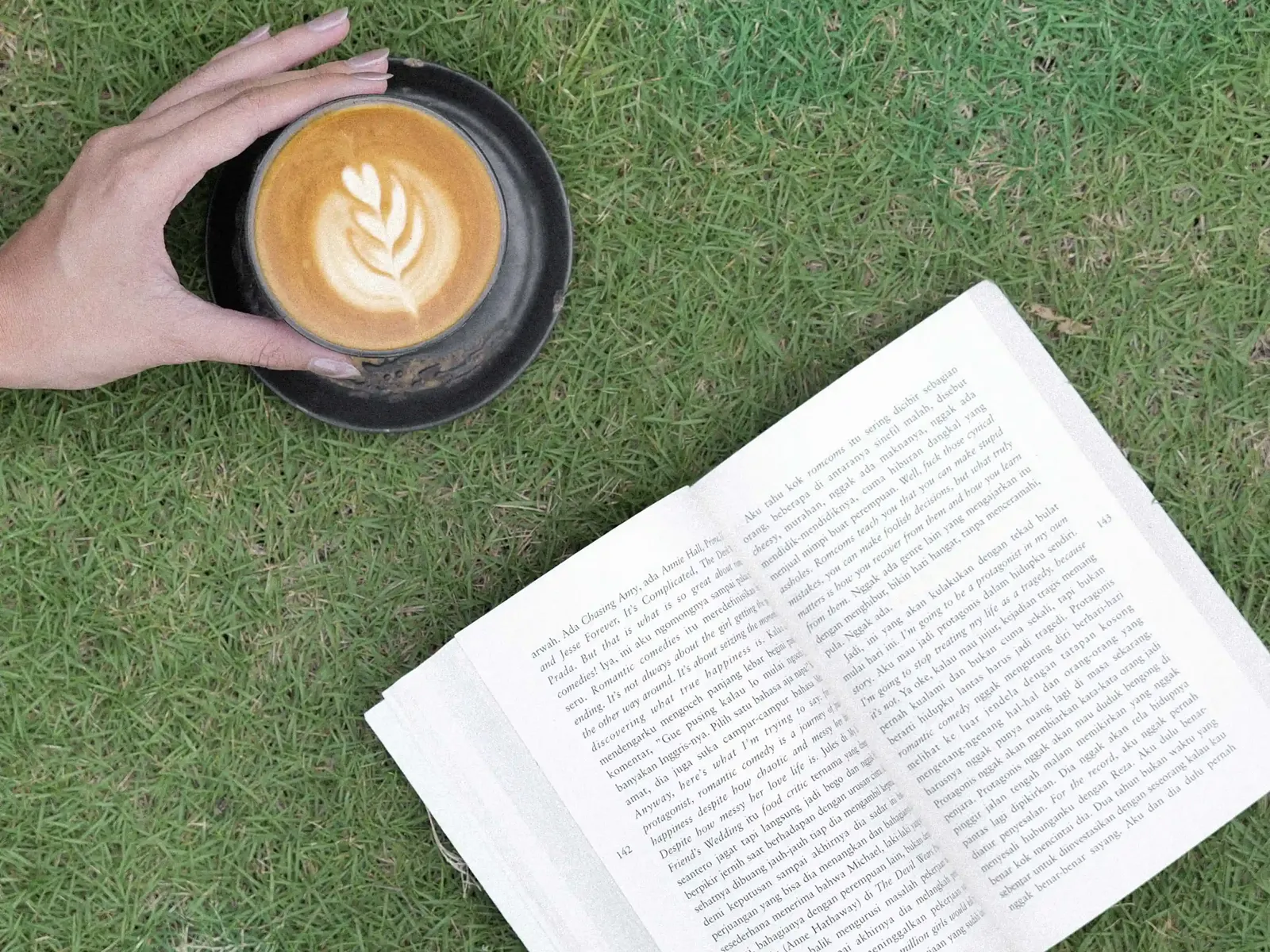 Balakosa Coffee latte art and book on grass