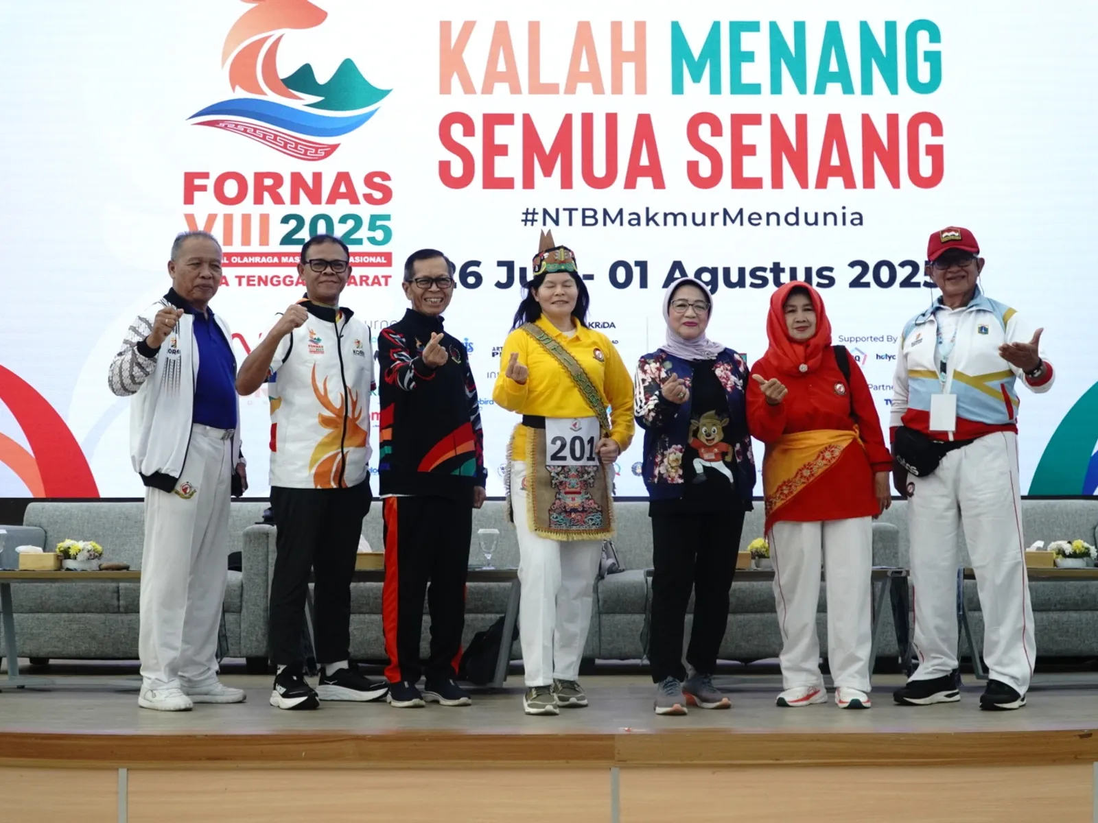 Group photo of officials and dignitaries at FORNAS VIII NTB 2025 event with event branding