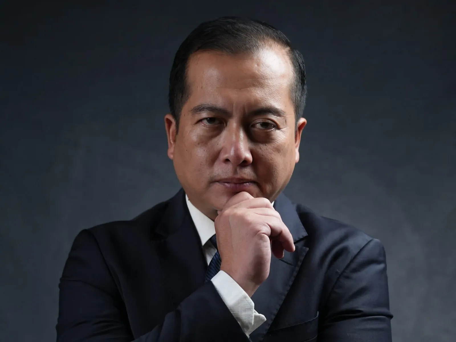 Professional portrait of gubernatorial candidate in a suit with thoughtful expression